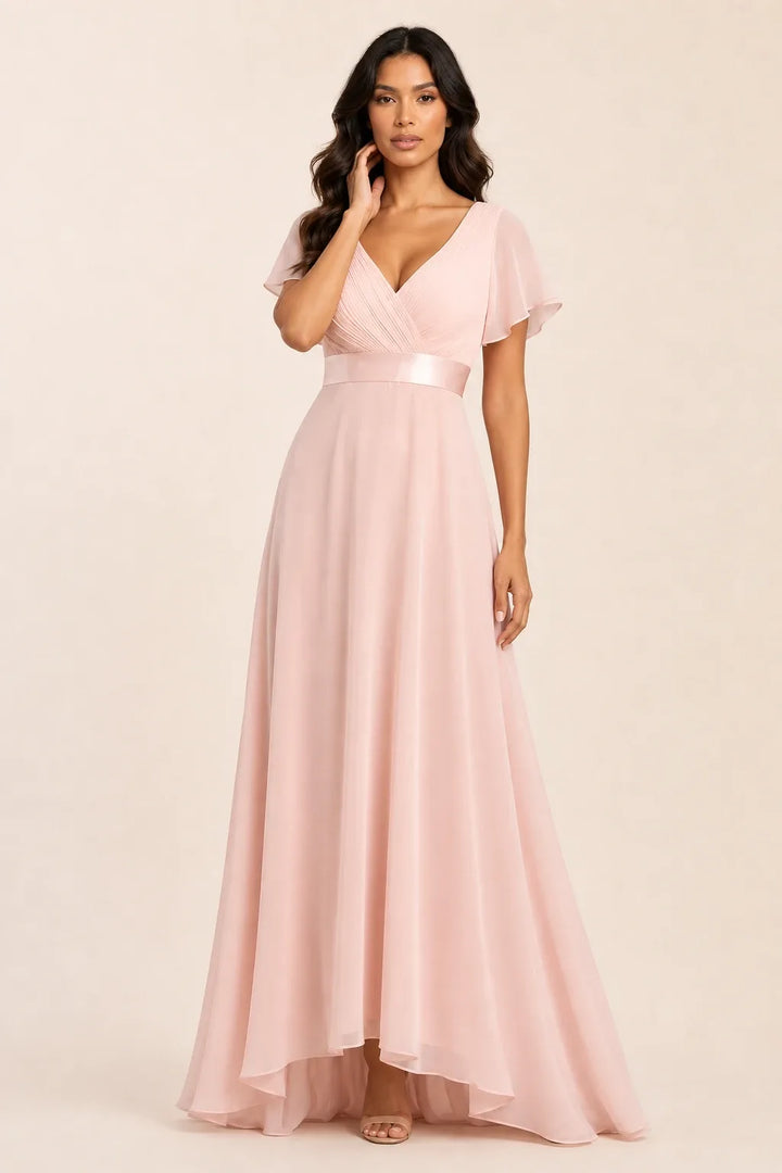 Pink flutter sleeve maxi dress on model in contrapposto stance