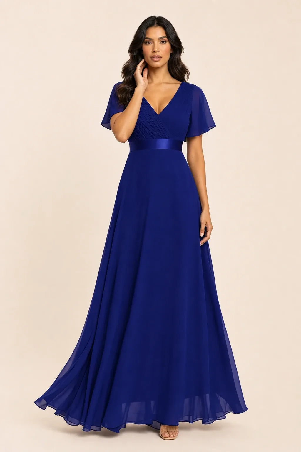 Sapphire blue flutter sleeve maxi dress on model in contrapposto stance