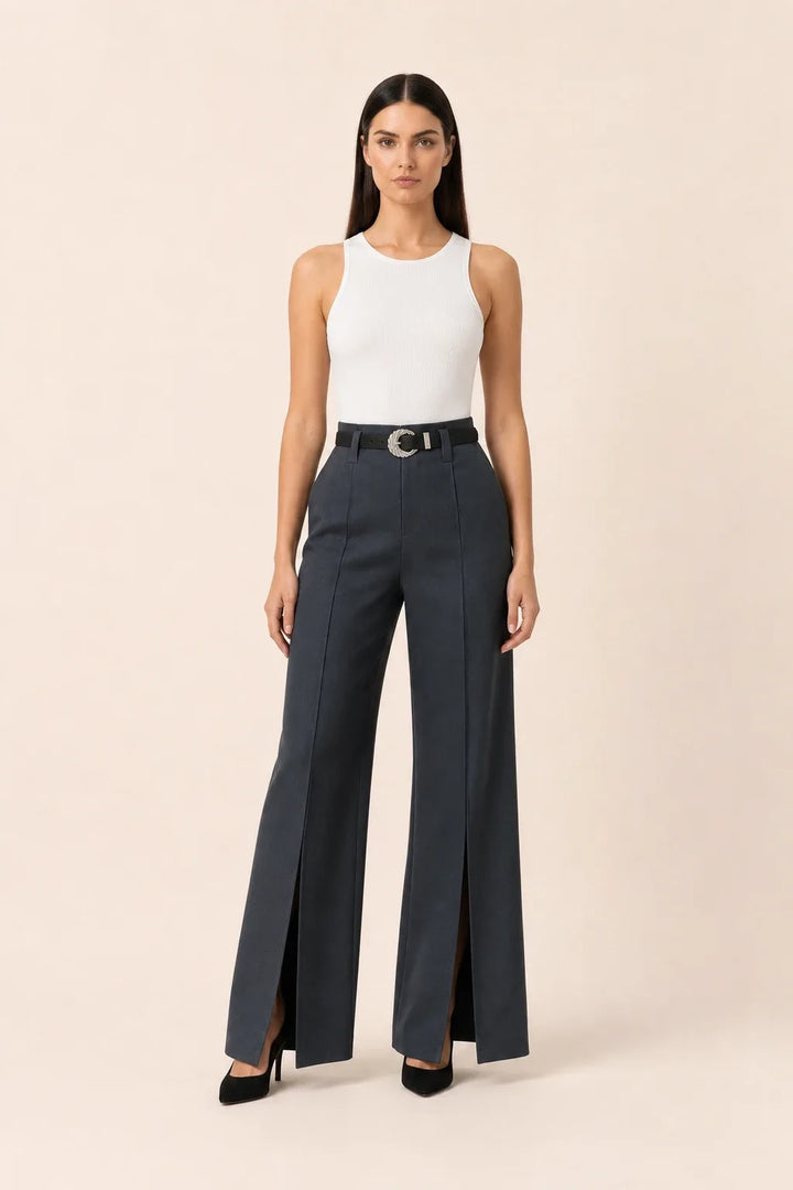 Dark grey wide leg pants with split hem, model in contrapposto stance