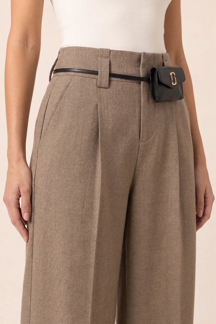Close-up detail of split hem on khaki wide leg pants