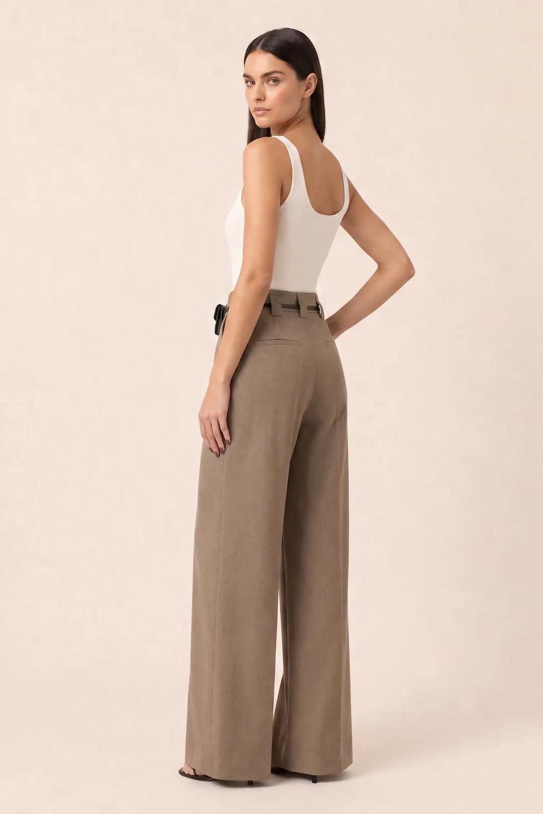 Khaki wide leg pants with split hem, model in three-quarter turn