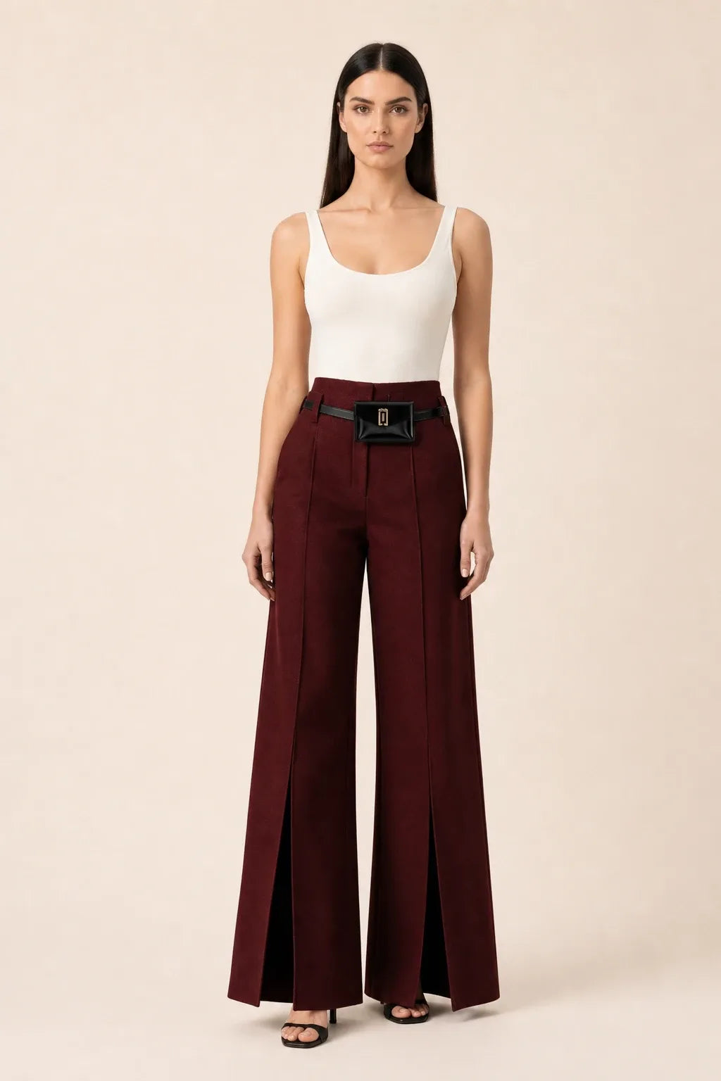 Wine red wide leg pants with split hem, model in contrapposto stance