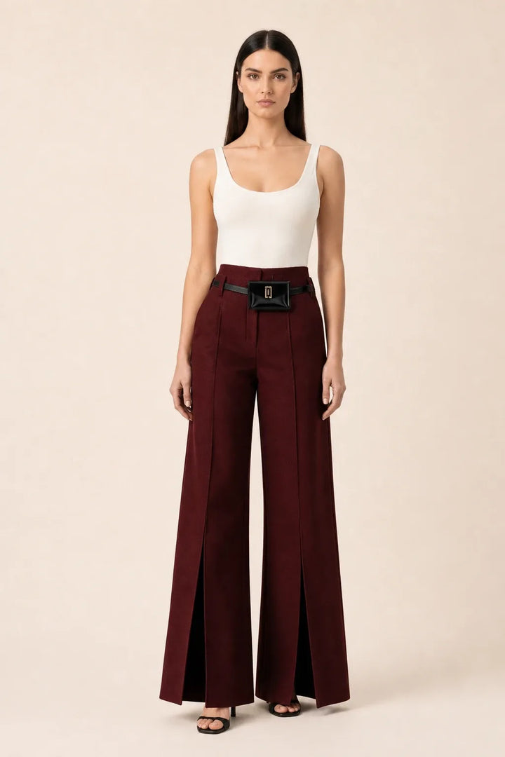 Wine red wide leg pants with split hem, model in contrapposto stance