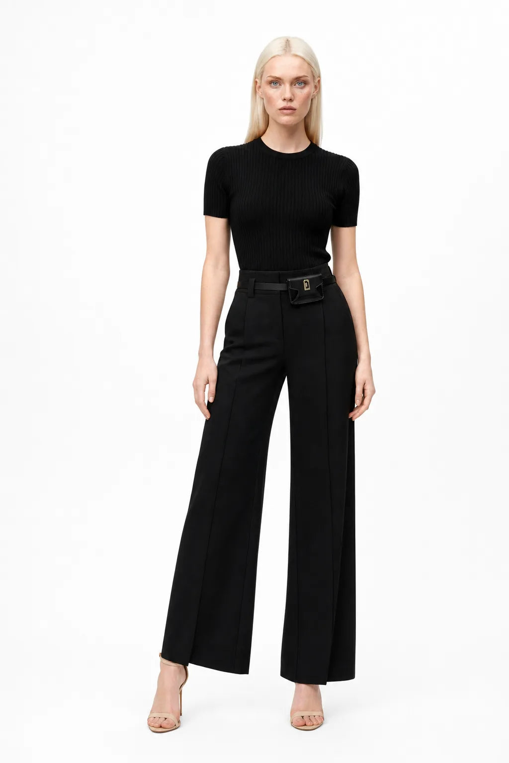 Black wide leg trousers with split hem, model in contrapposto stance