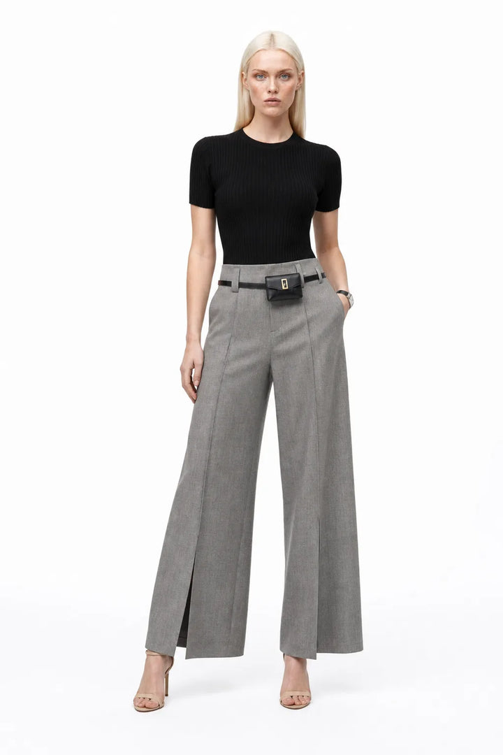 Grey wide leg trousers with split hem, model in contrapposto stance