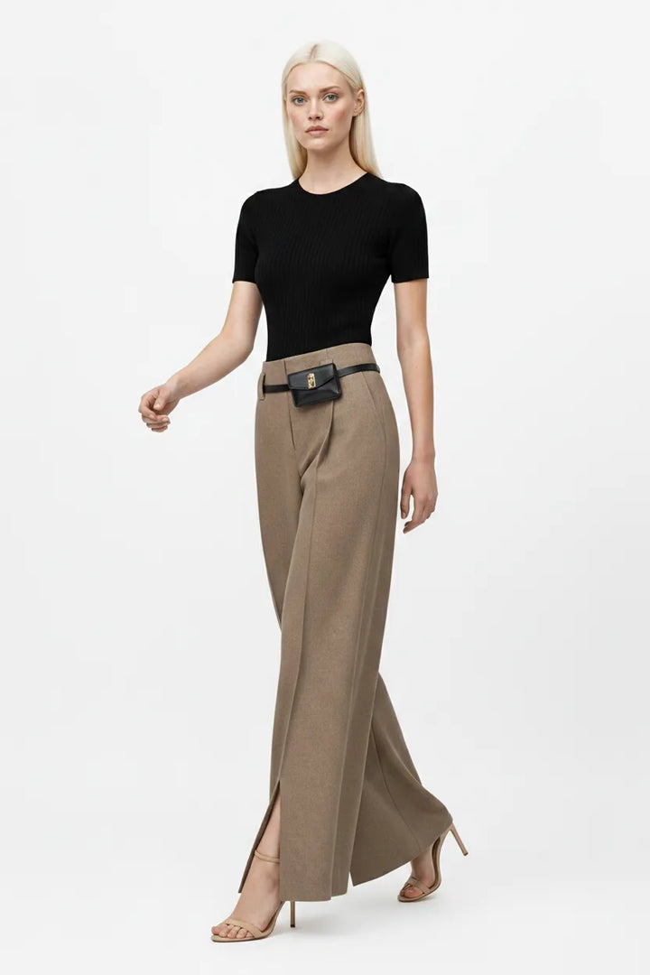 Khaki wide leg trousers with split hem, model in natural movement pose