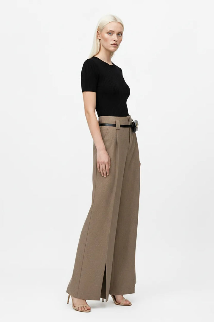 Khaki wide leg trousers with split hem, model in three-quarter turn