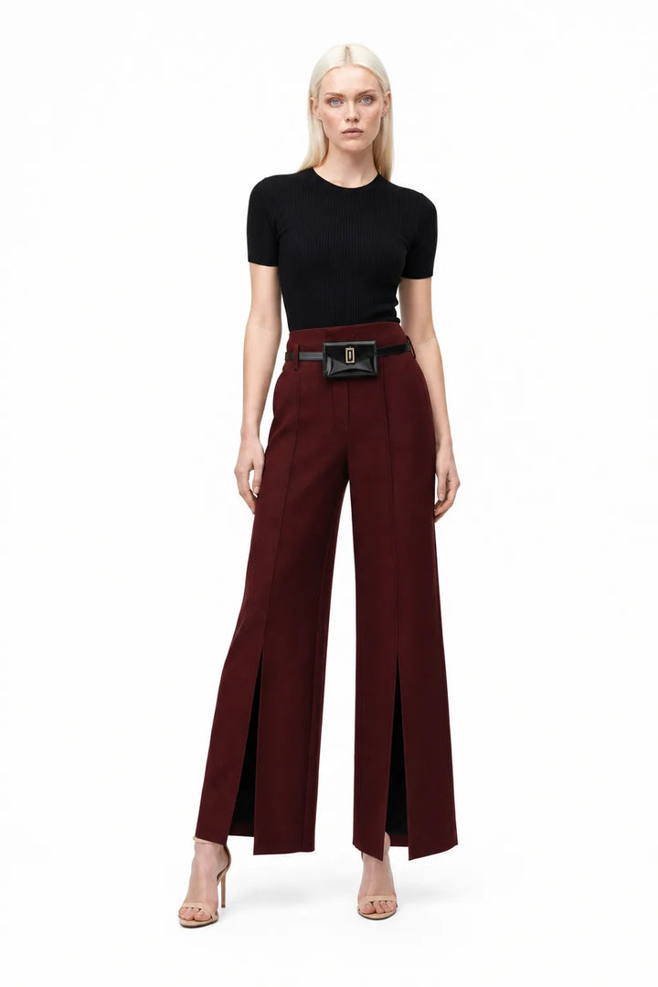 Wine red wide leg trousers with split hem, model in contrapposto stance