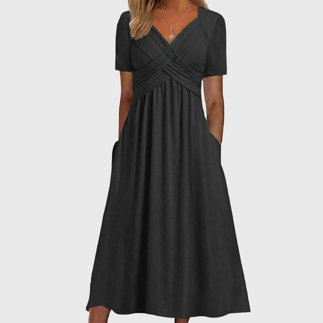 Black cross-wrap midi dress on model, full-length view