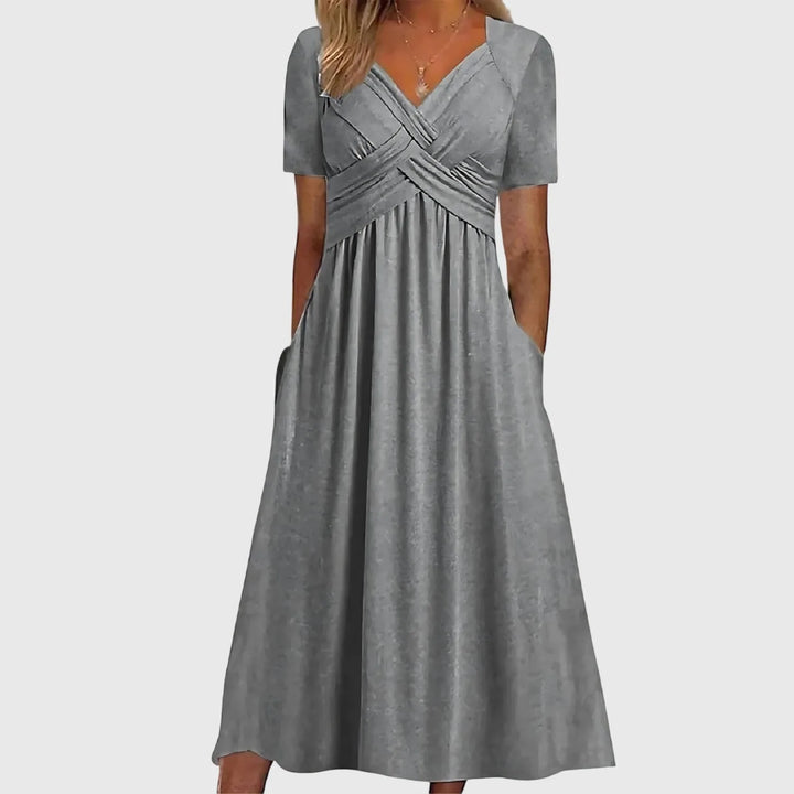 Gray cross-wrap midi dress on model in side profile
