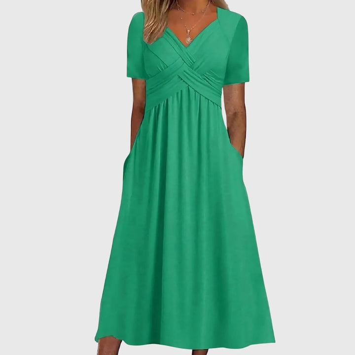 Green cross-wrap midi dress on model facing forward