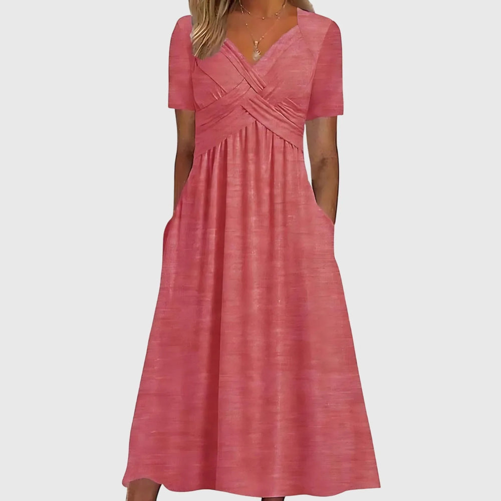 Close-up detail of pink cross-wrap midi dress fabric and wrap tie