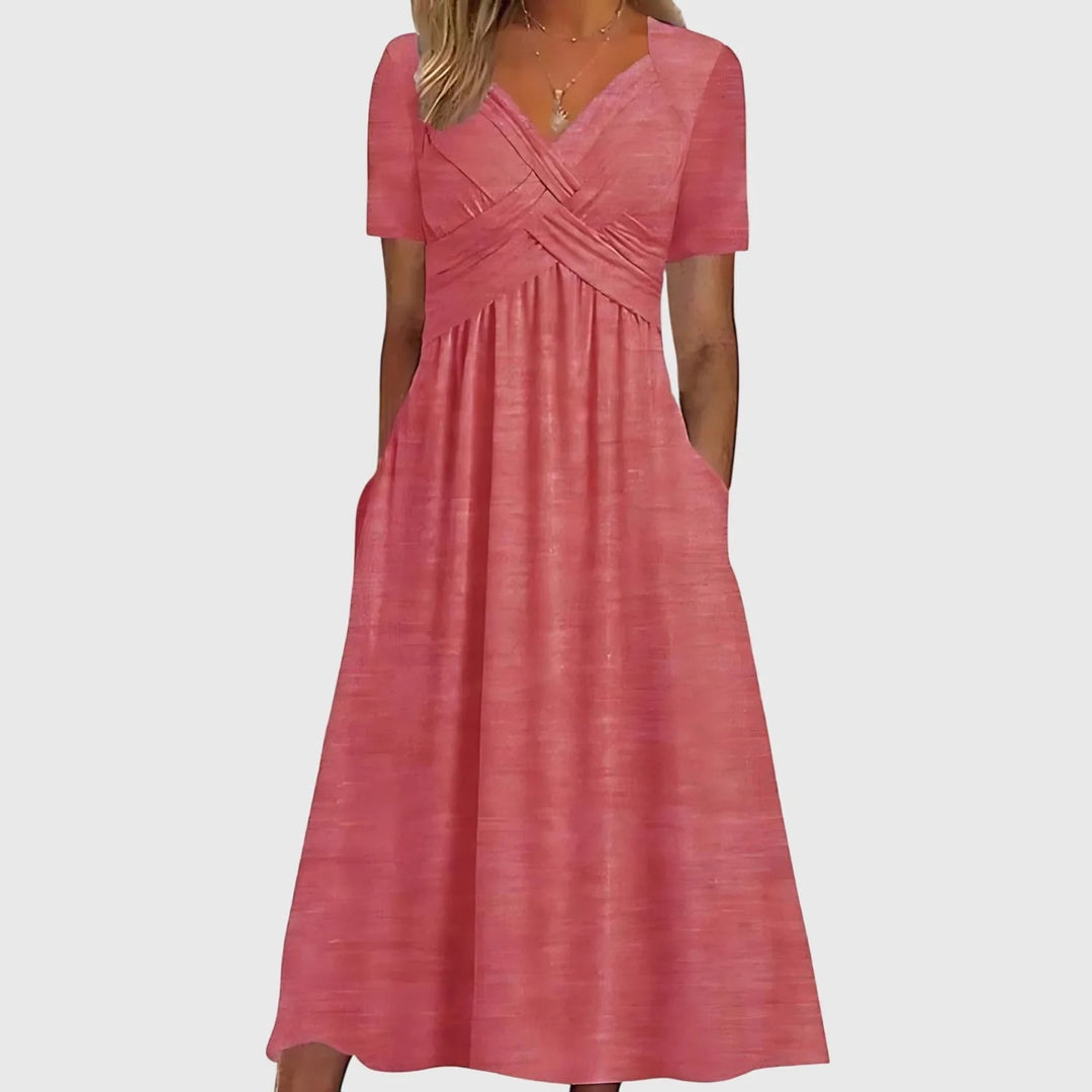 Close-up detail of pink cross-wrap midi dress fabric and wrap tie