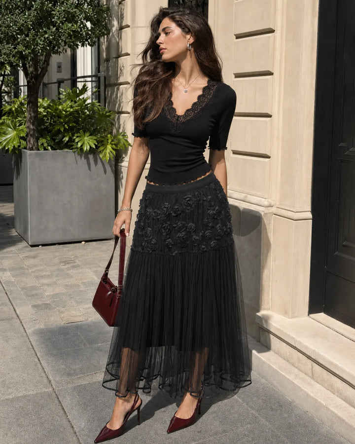 Black midi dress with rose appliqués, model facing forward
