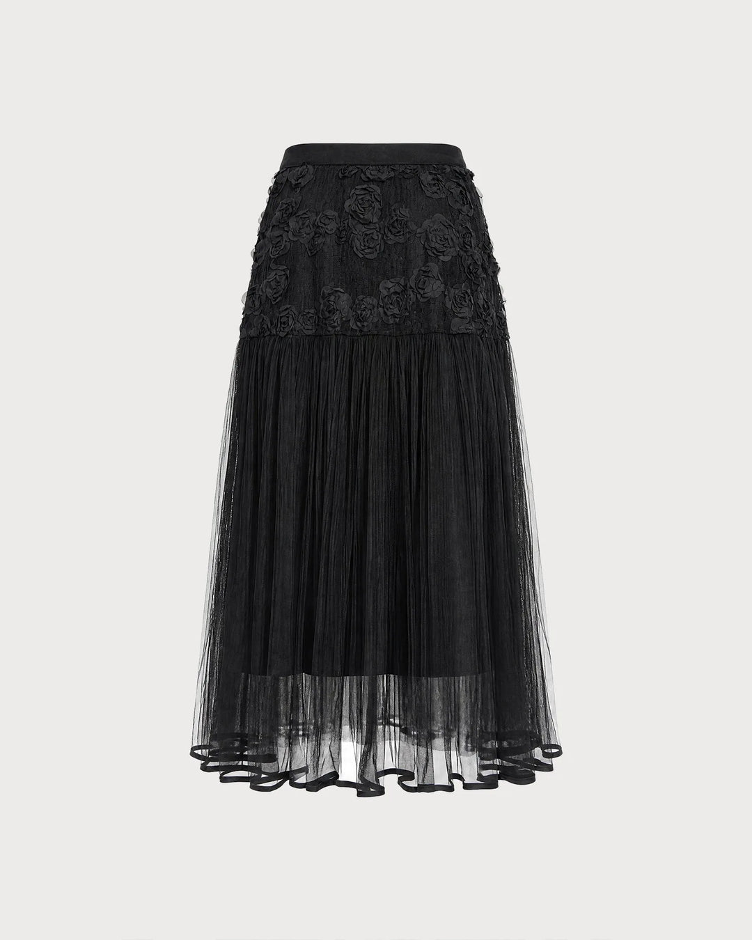Black midi dress with floral appliqués, model in side profile