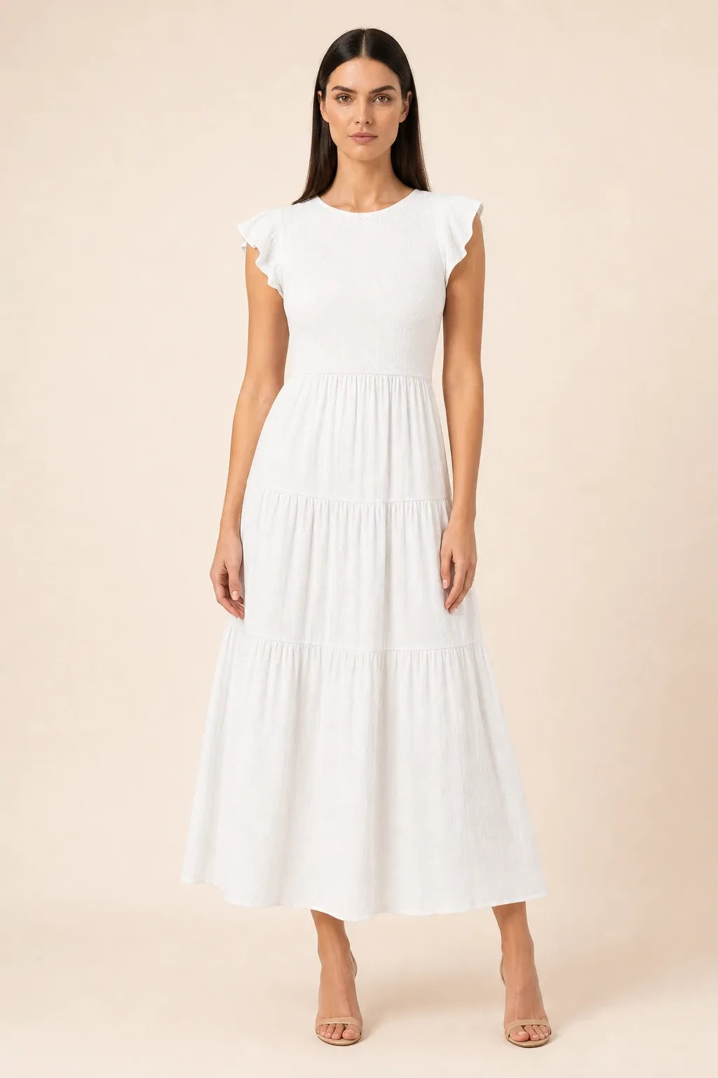 White smocked tiered midi dress on model in contrapposto stance