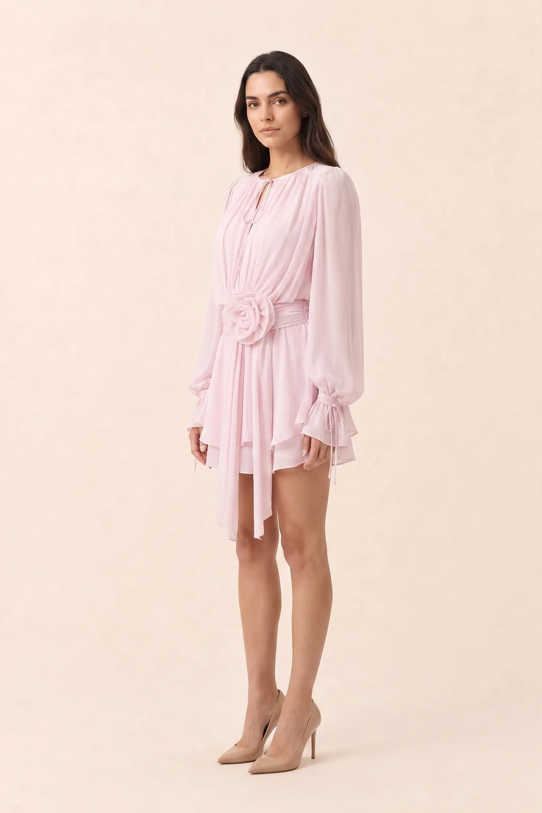 White rosette sash mini dress on model in three-quarter turn