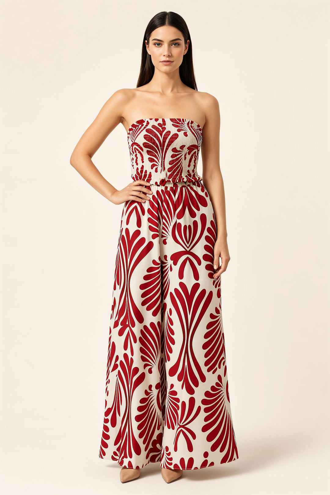 Red smocked print jumpsuit on model in contrapposto stance