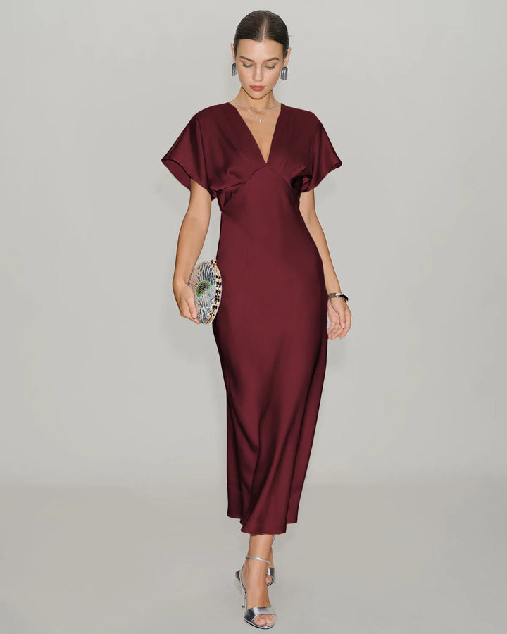 Close-up detail of wine red flutter sleeve midi dress fabric and sleeve