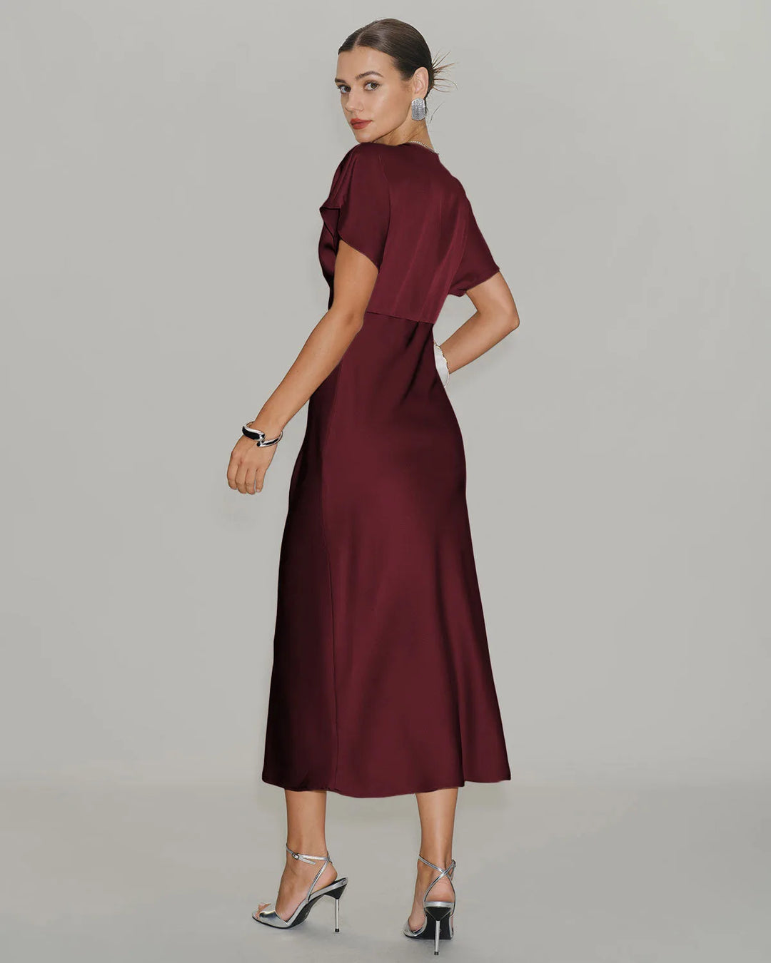 Wine red flutter sleeve midi dress on model in alternate styled view