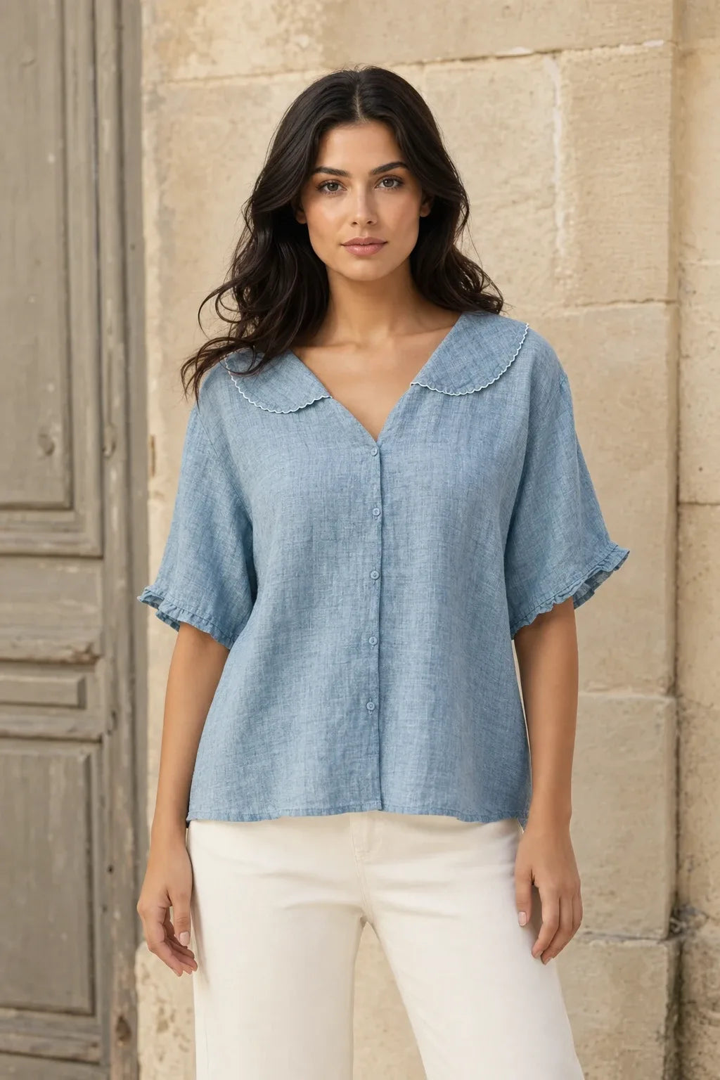 Blue Peter Pan collar blouse on model in contrapposto stance