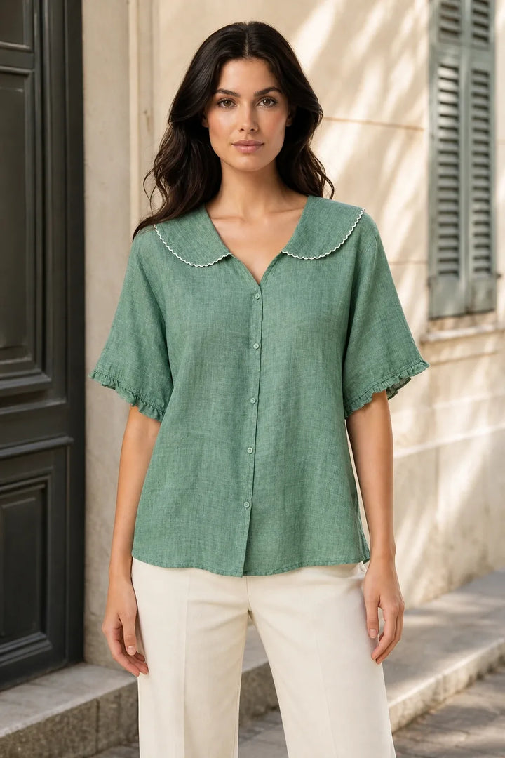 Green Peter Pan collar blouse on model in contrapposto stance