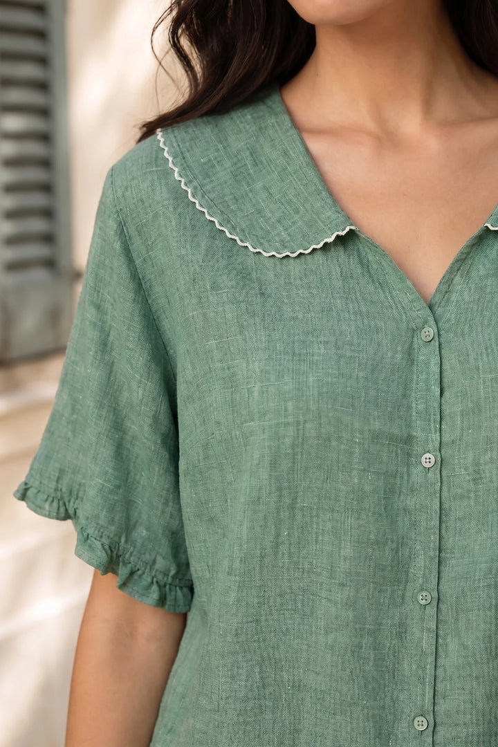 Close-up detail of green Peter Pan collar blouse