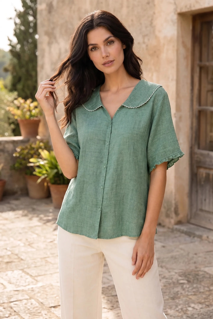 Model wearing green Peter Pan collar blouse in lifestyle setting