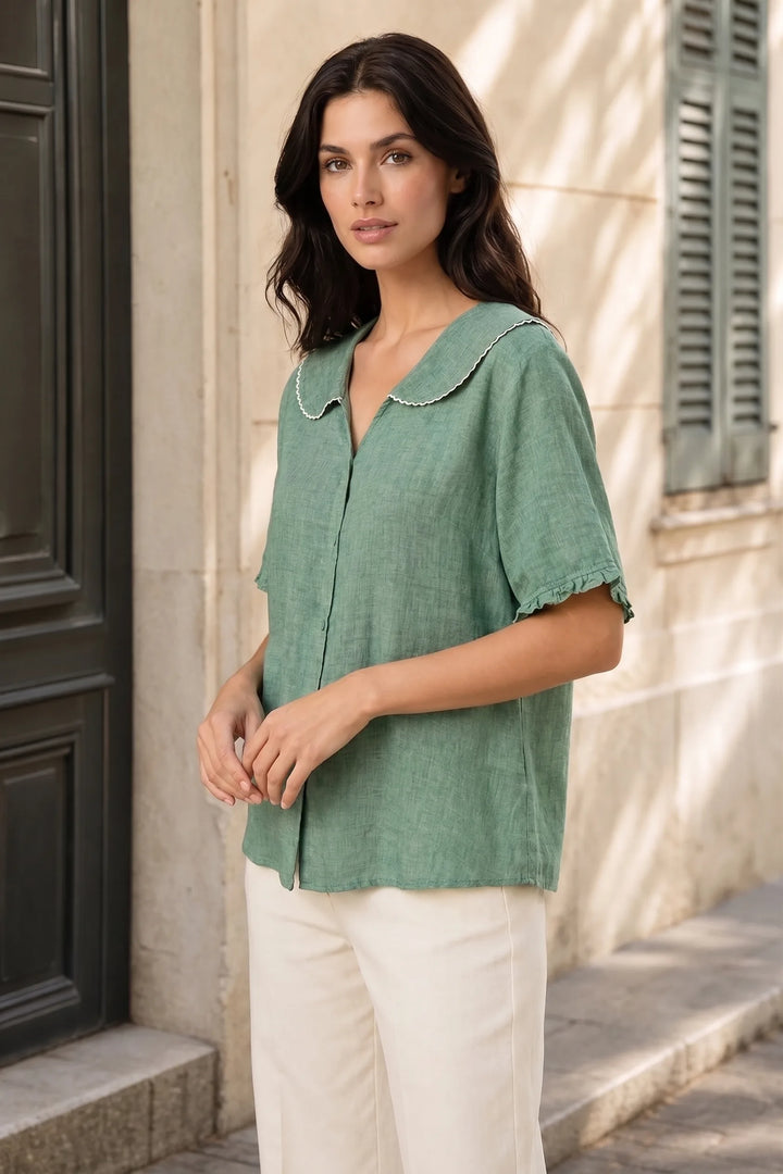 Green Peter Pan collar blouse on model in three-quarter turn