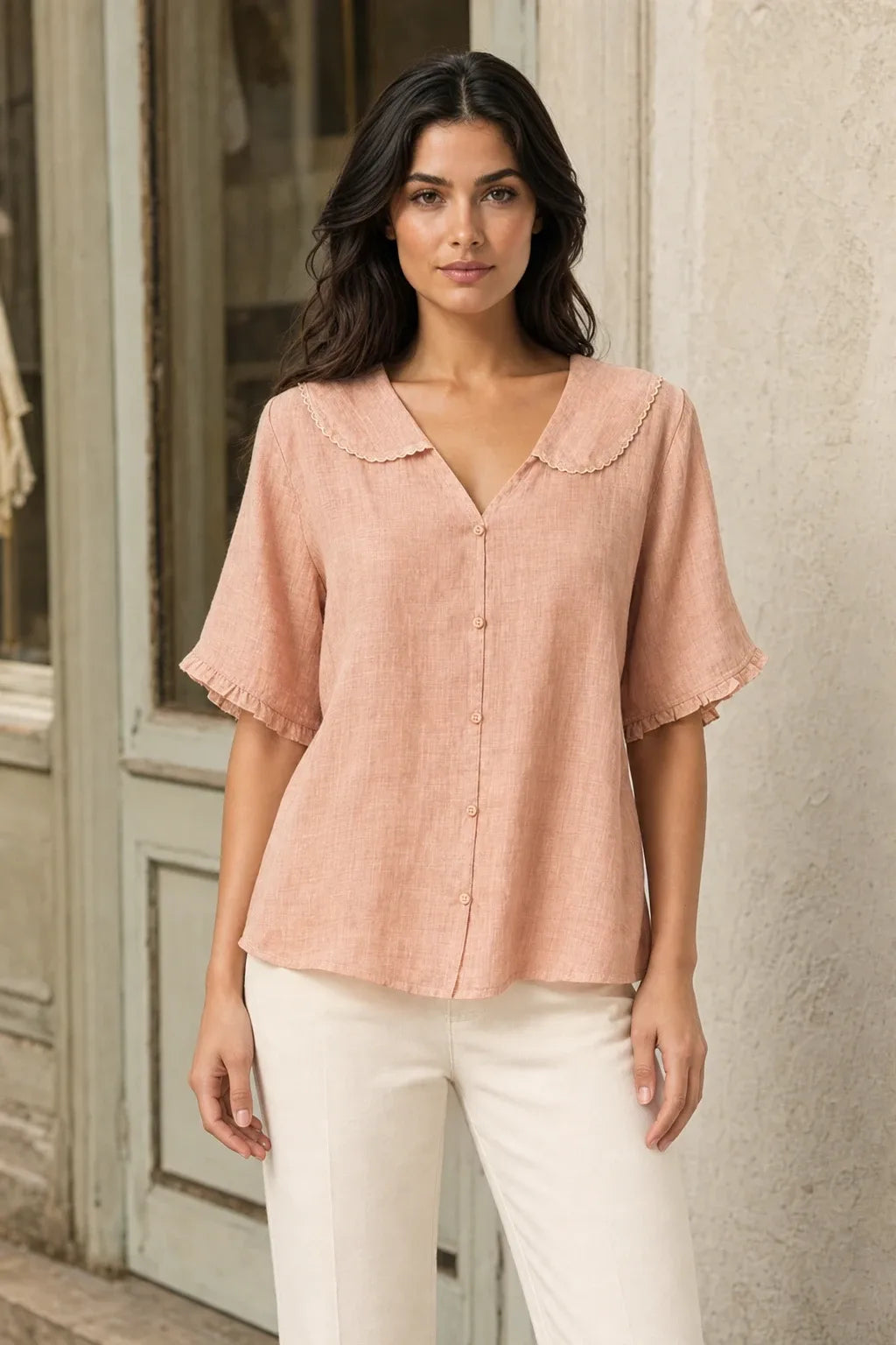 Peach Peter Pan collar blouse on model in contrapposto stance