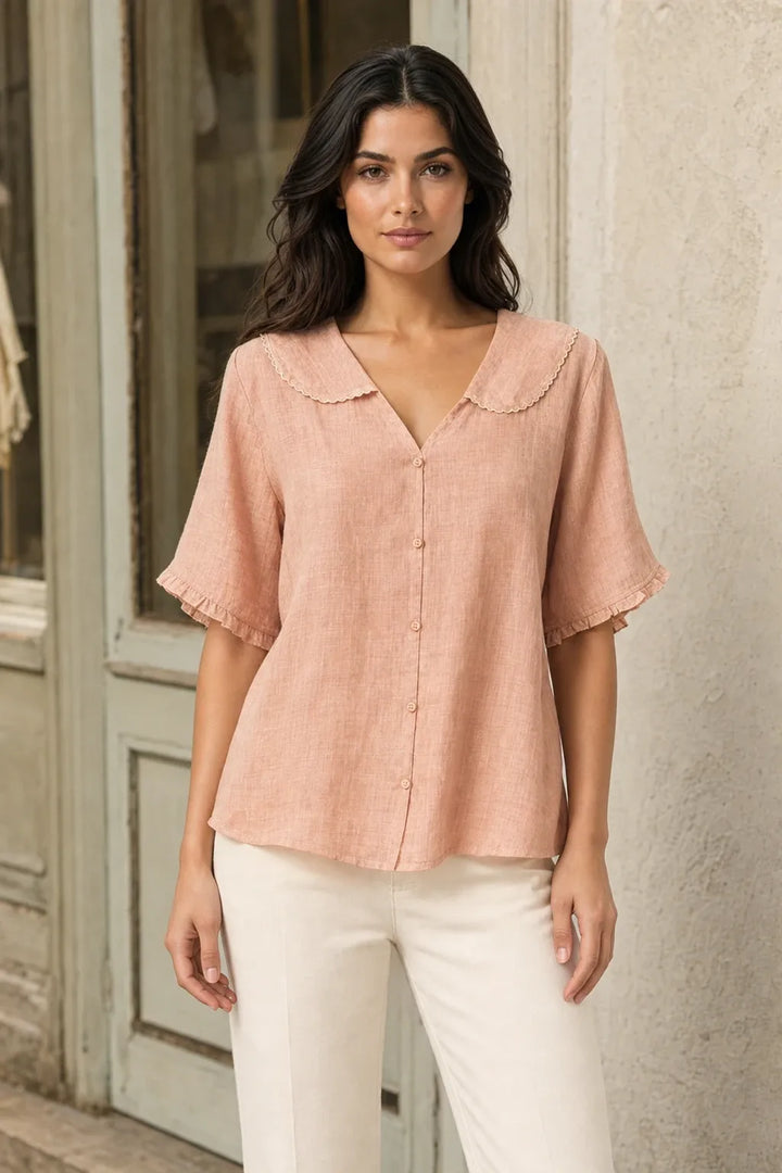 Peach Peter Pan collar blouse on model in contrapposto stance