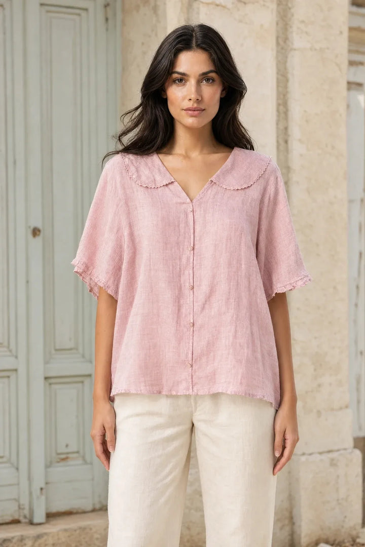 Pink Peter Pan collar blouse on model in contrapposto stance