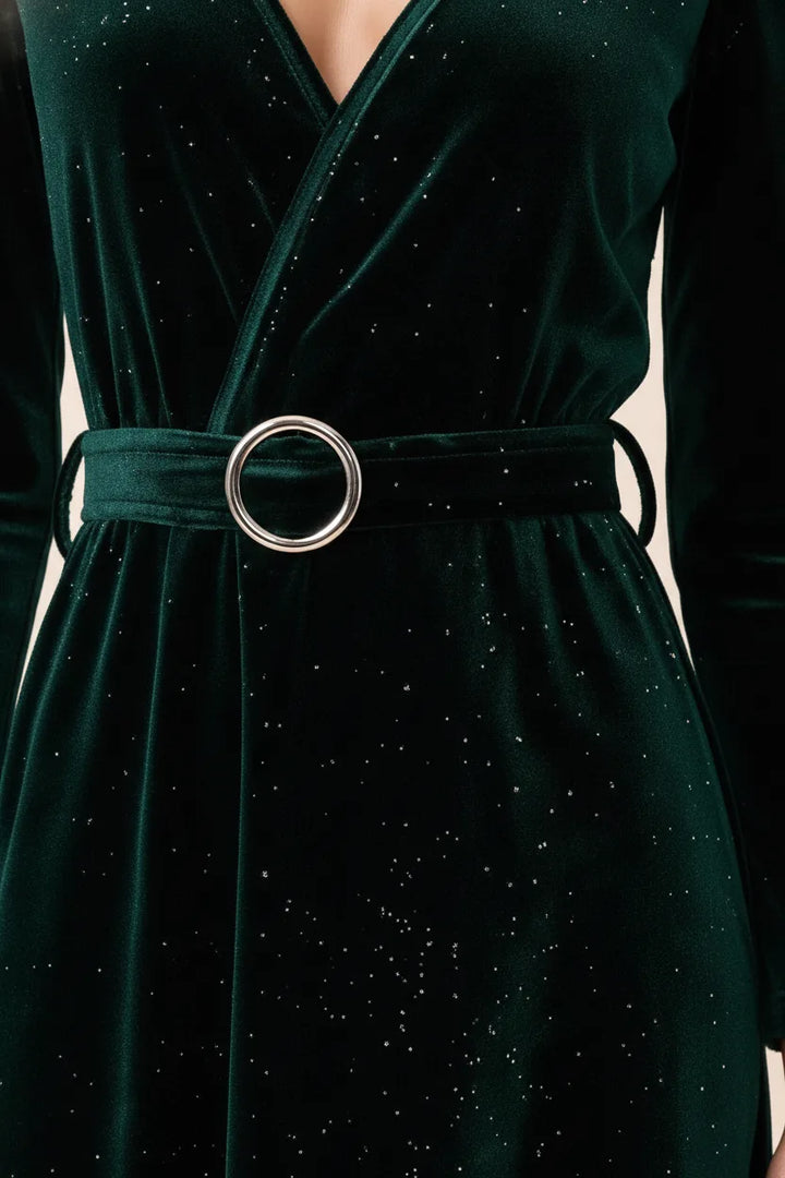 Close-up detail of dark green glitter velvet wrap midi dress fabric and wrap tie