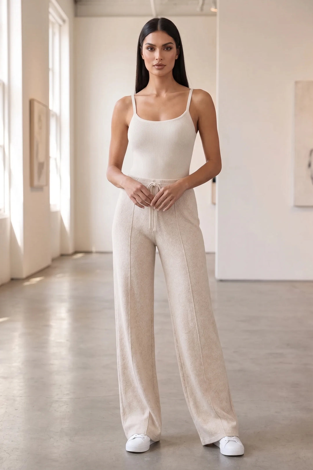 Model wearing beige knit wide-leg pants in a lifestyle setting