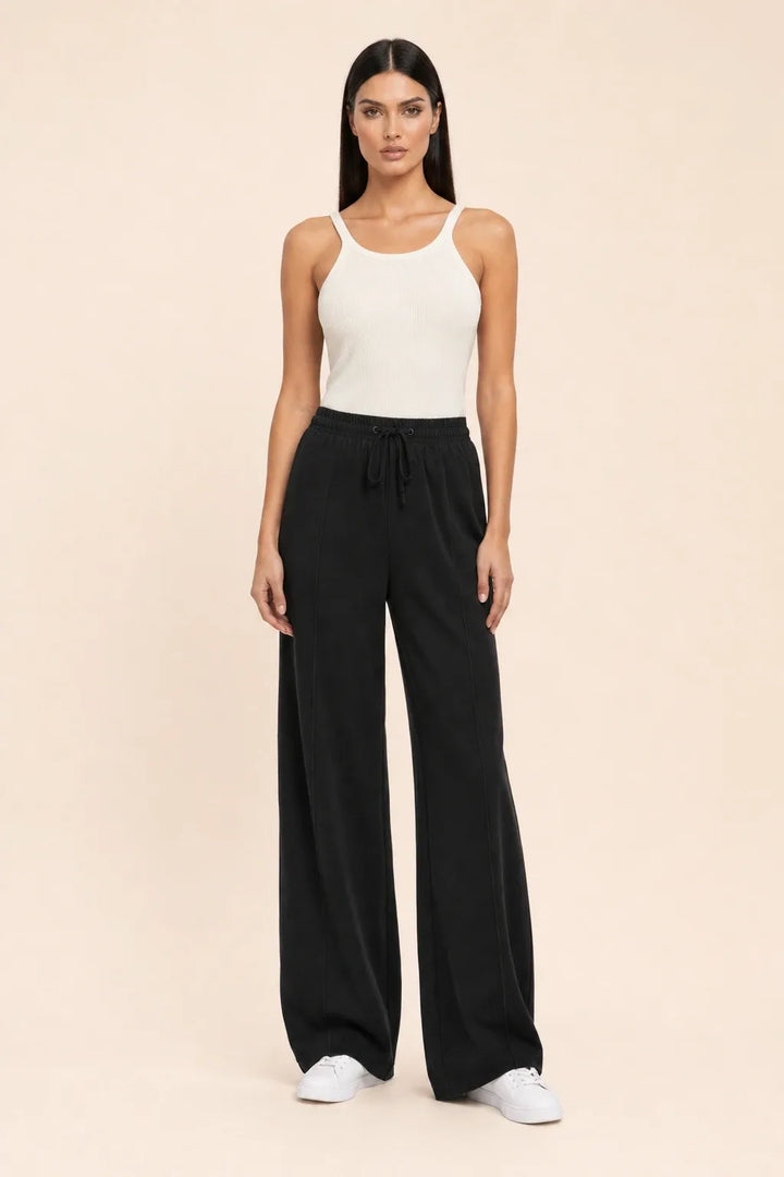 Black knit wide-leg pants on a model in a contrapposto stance