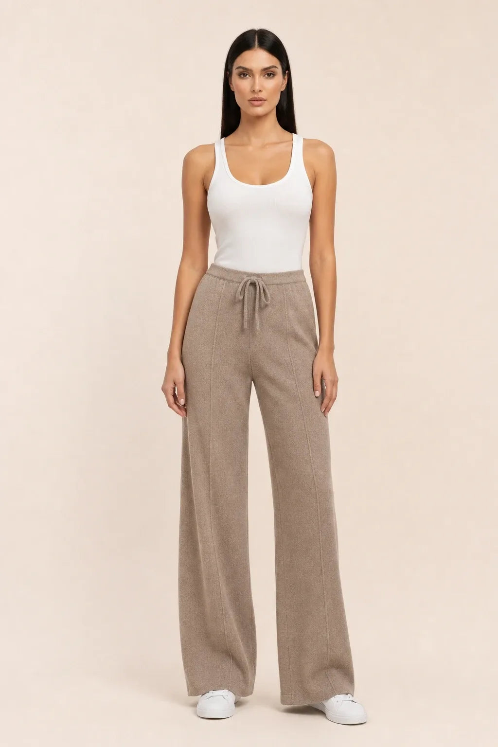 Brown knit wide-leg pants on a model in a contrapposto stance
