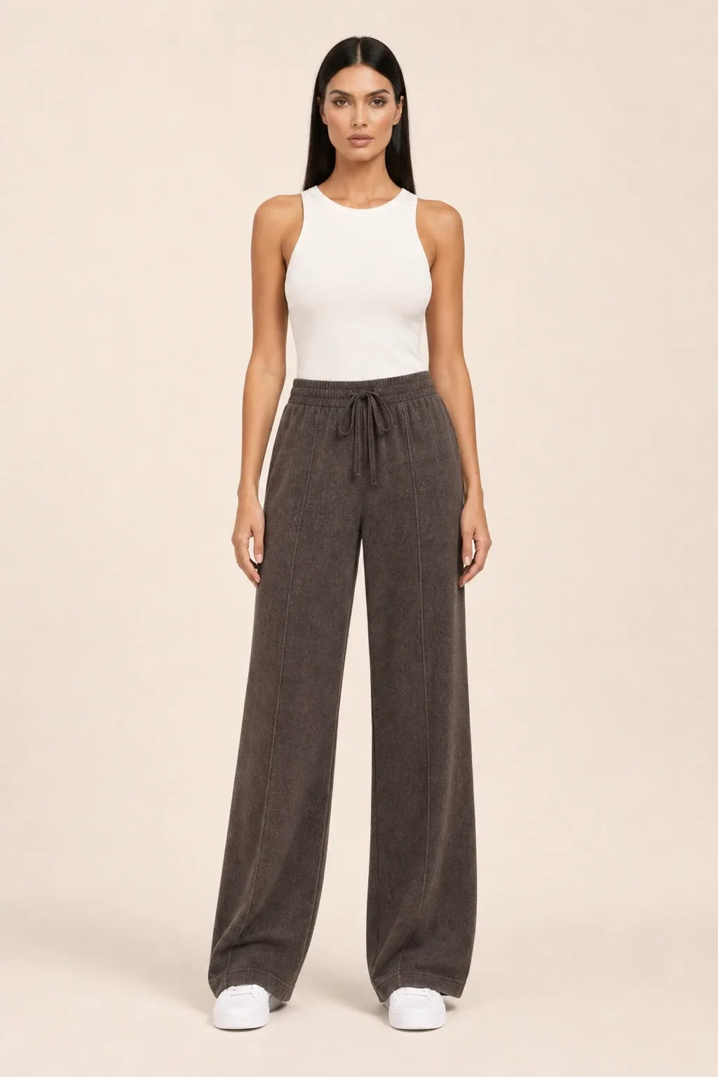 Coffee-toned knit wide-leg pants on a model in a contrapposto stance