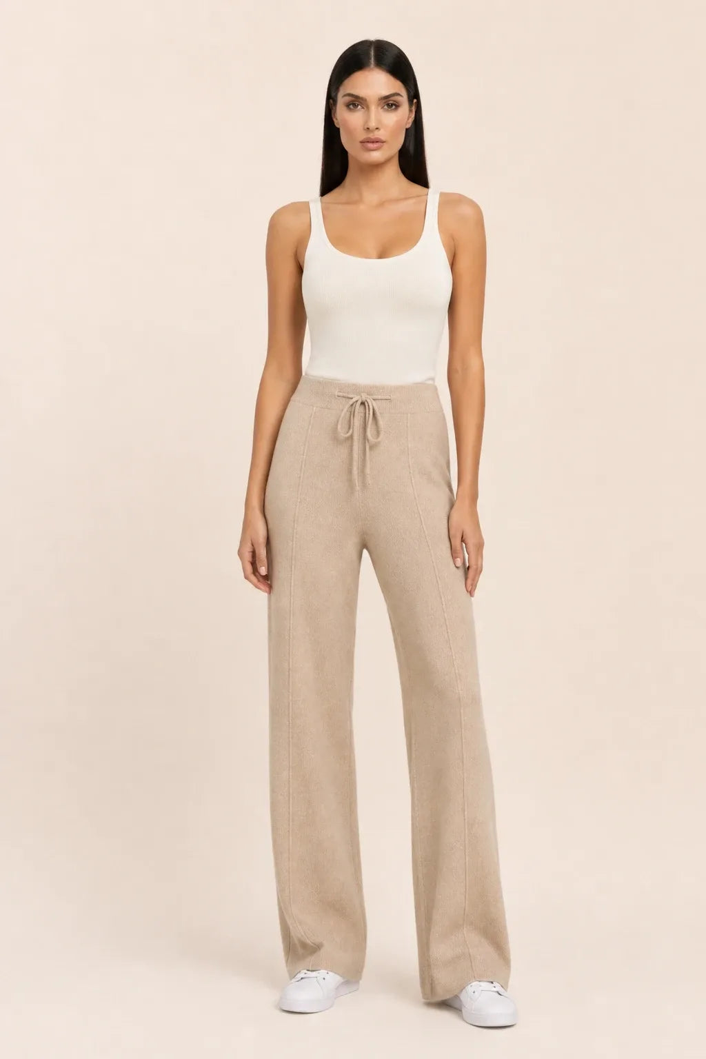 Khaki knit wide-leg pants on a model in a contrapposto stance