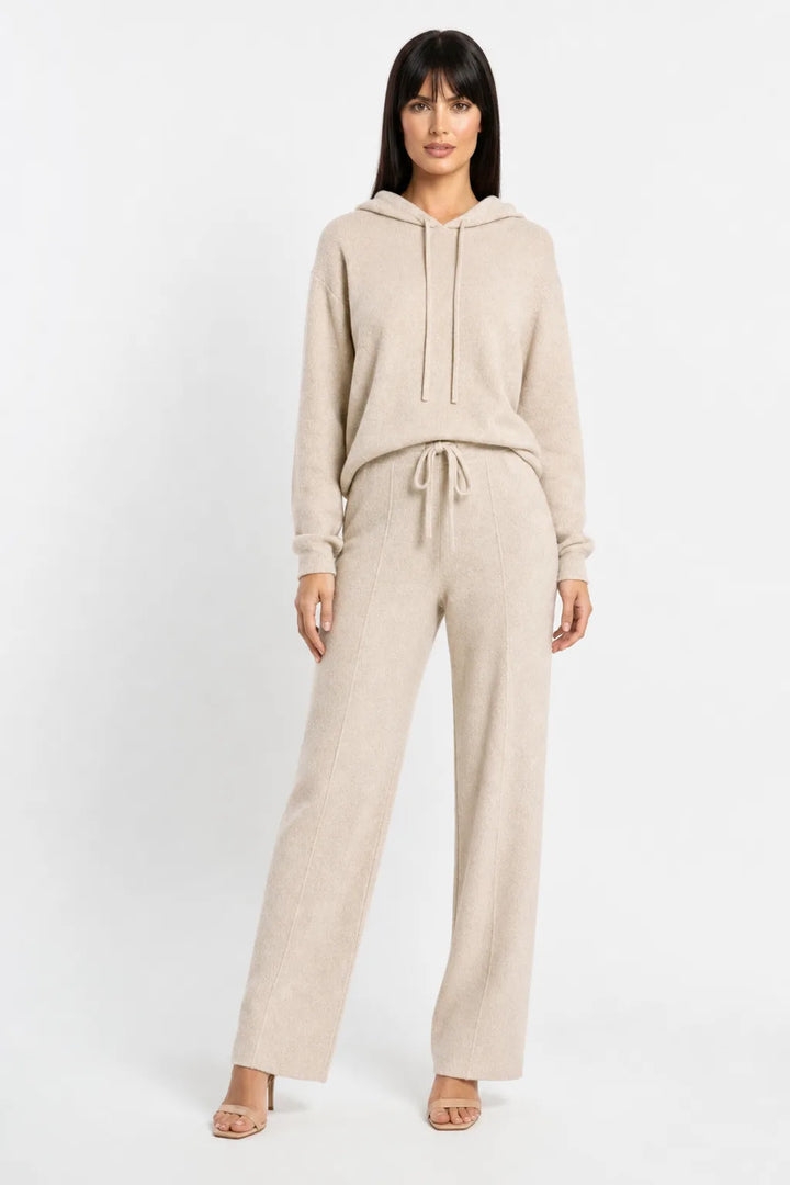 Beige knit wide-leg trousers on a model in a contrapposto stance