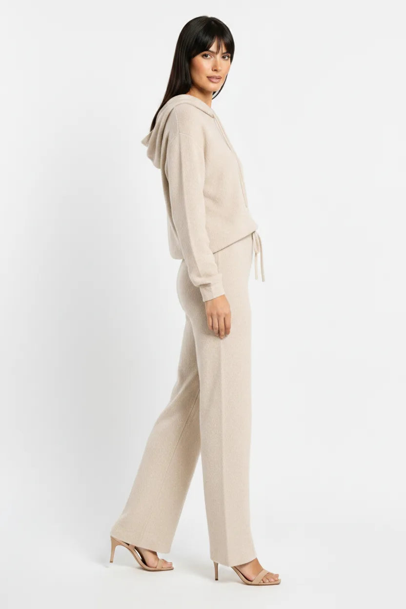 Beige knit wide-leg trousers on a model in a three-quarter turn