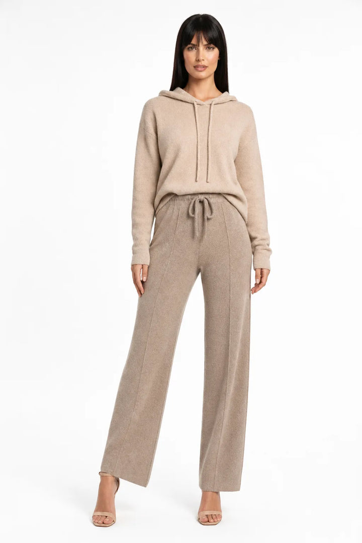 Brown knit wide-leg trousers on a model in a contrapposto stance