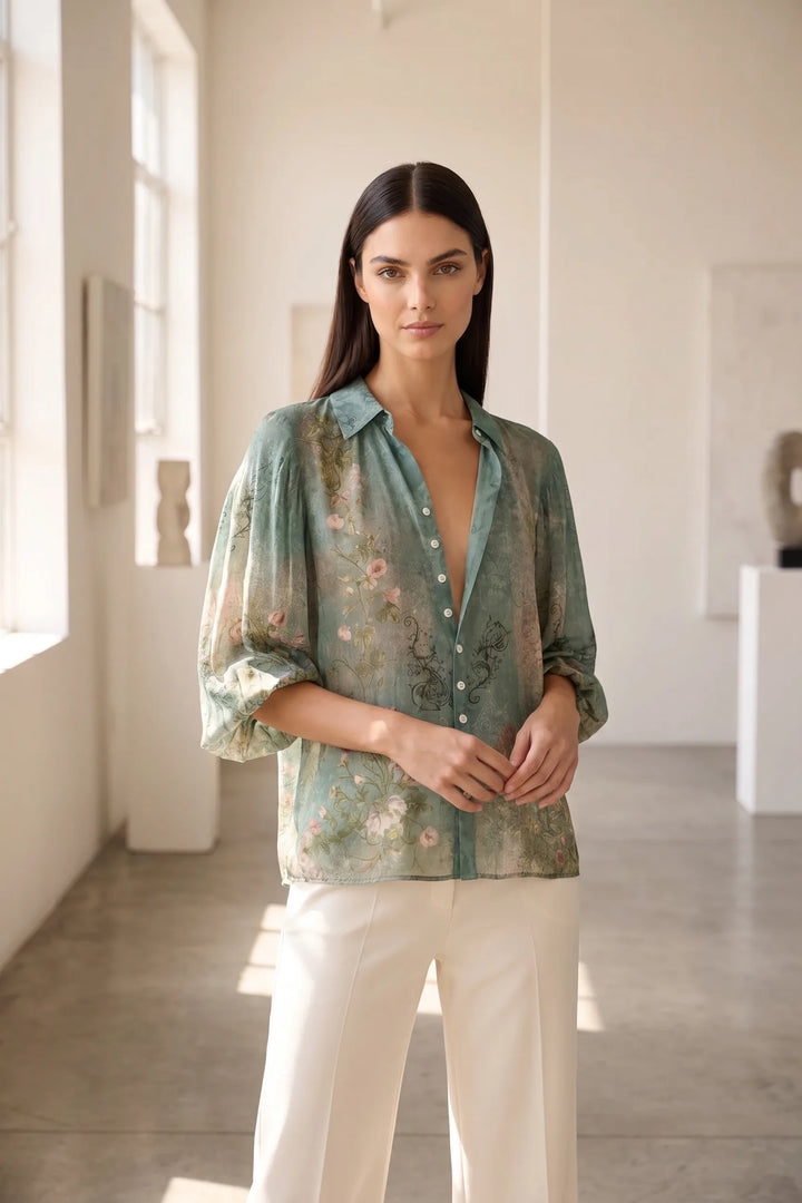 Model wearing a green floral balloon sleeve blouse in a lifestyle setting