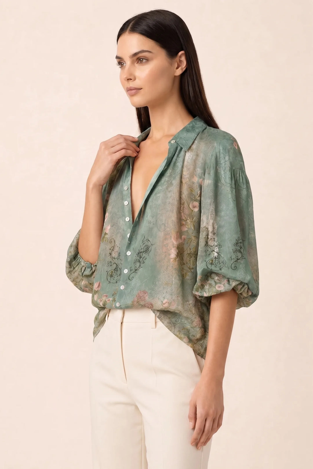 Green floral balloon sleeve blouse on a model in a three-quarter turn pose