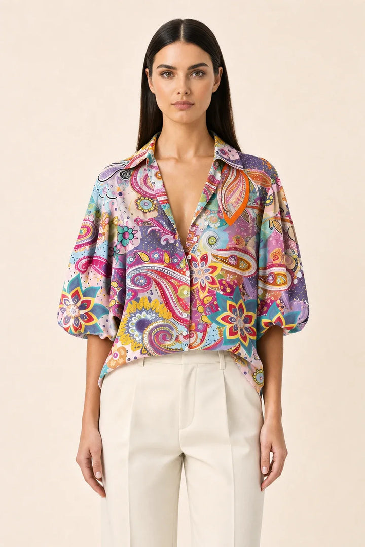 Pink floral blouse with balloon sleeves on a model in a contrapposto stance