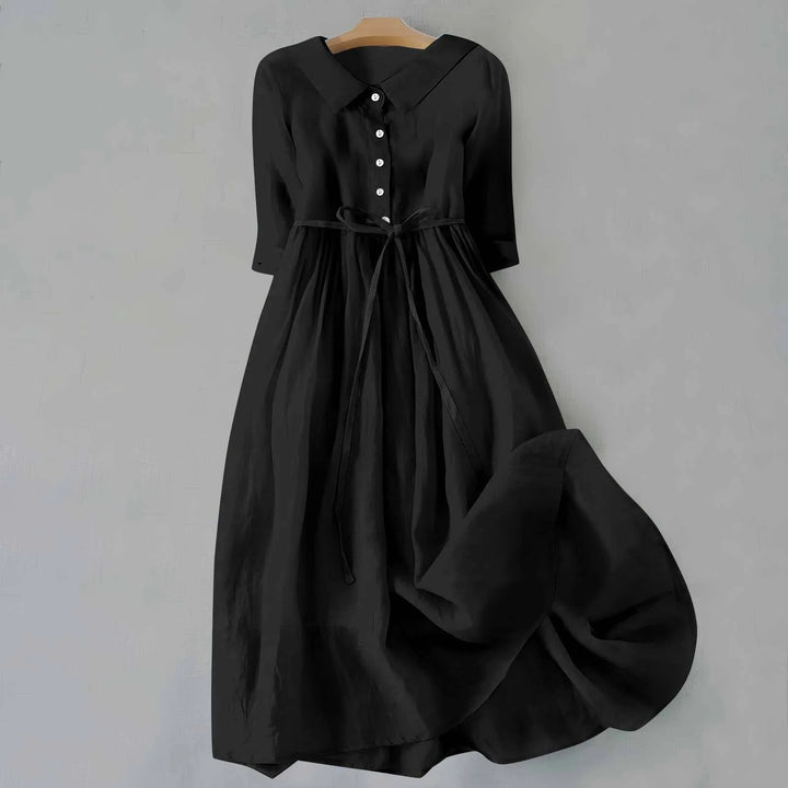 Close-up detail of black midi dress with Peter Pan collar
