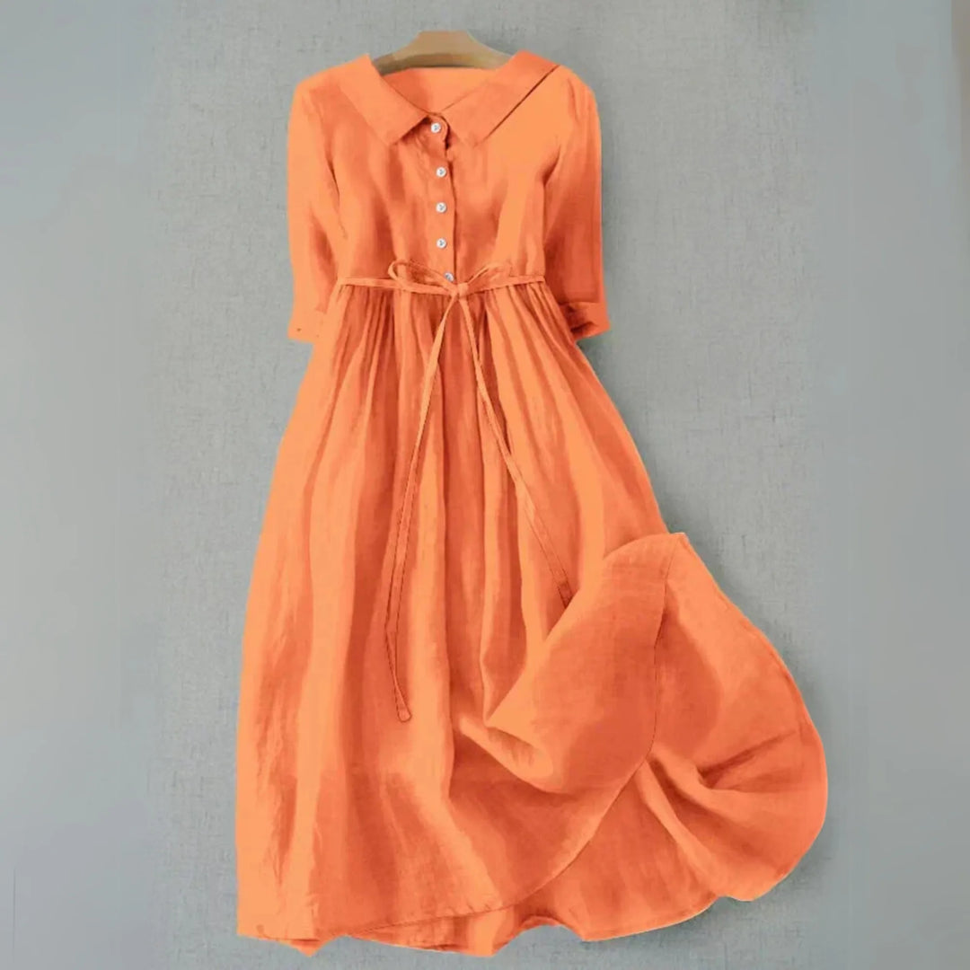 Orange midi dress with Peter Pan collar, model facing forward