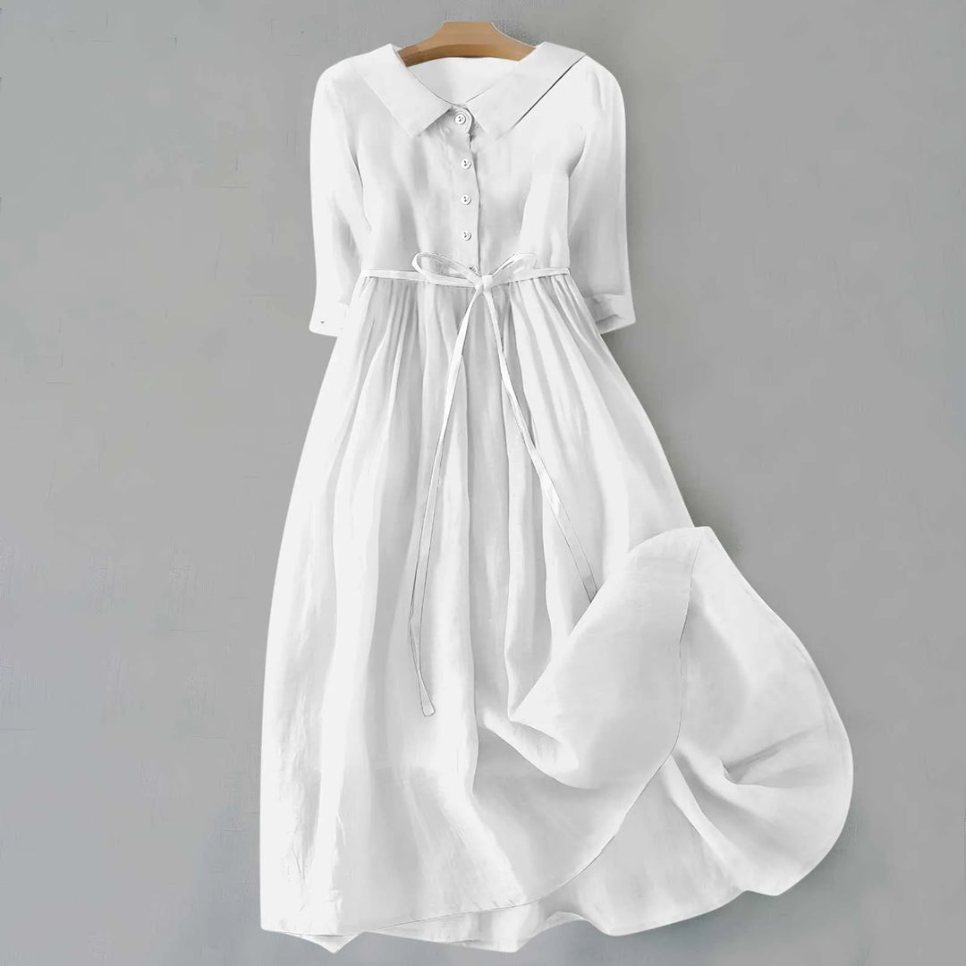 White midi dress with Peter Pan collar, model in side profile