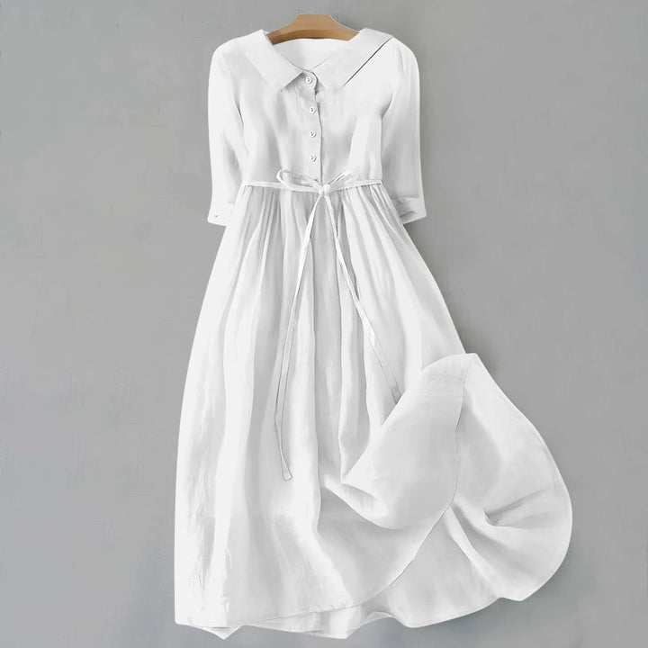 White midi dress with Peter Pan collar, model in side profile