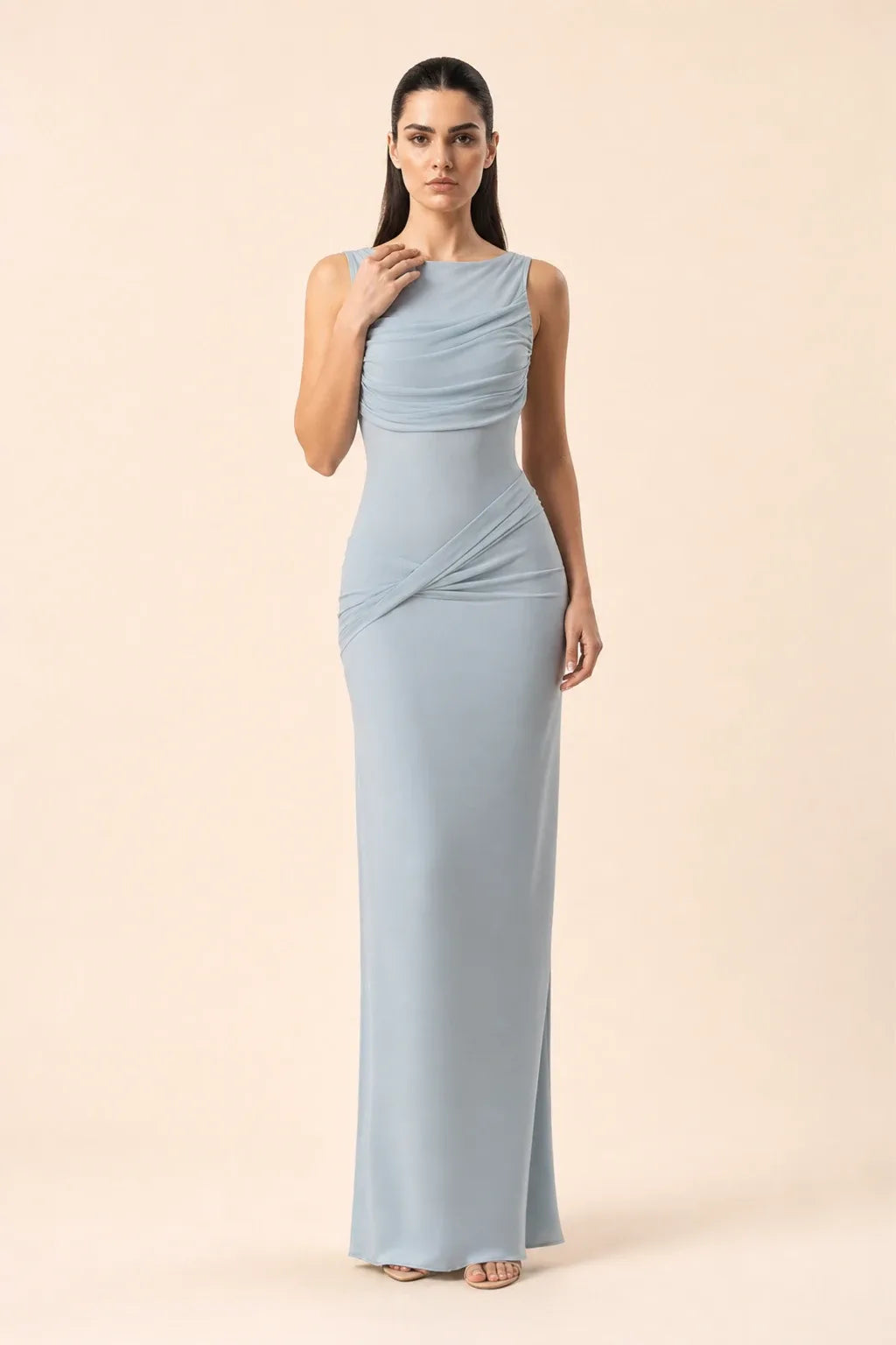 Blue ruched open-back gown on model in contrapposto stance