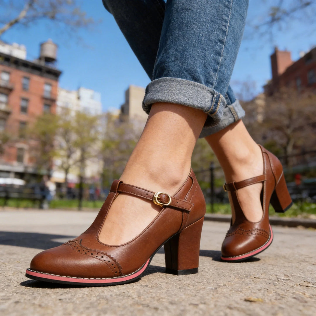 Black leather T-bar brogue pump, three-quarter angle showing brogue trim and silhouette